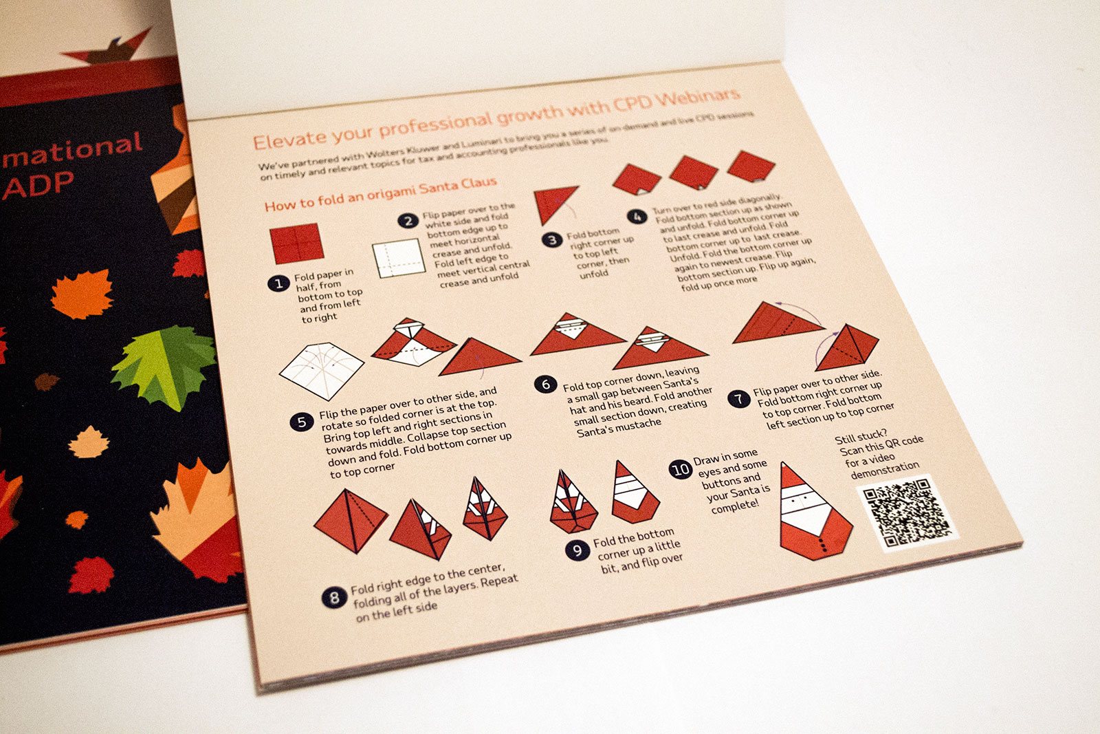 inside page of instructions for folding an origami santa with a QR code at the bottom to scan for a video demonstration